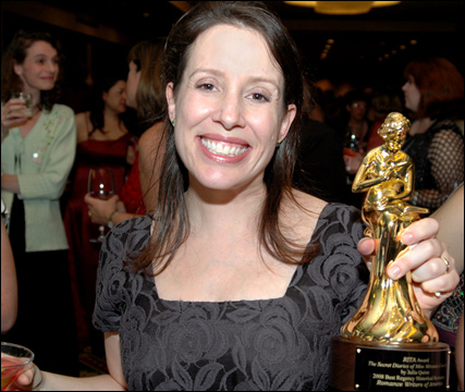 Julia Quinn with her RITA in her MacGyvered-with-stickers dress. Editor Lyssa Keusch in background left.